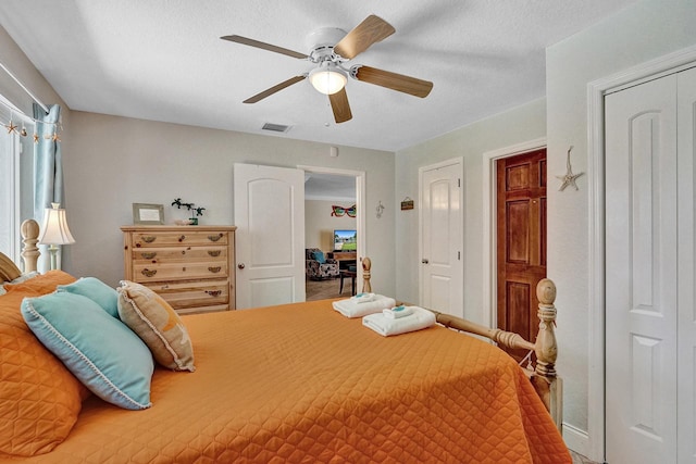 bedroom with a textured ceiling and ceiling fan