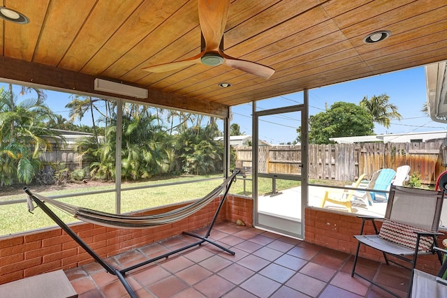 sunroom / solarium with wood ceiling and ceiling fan