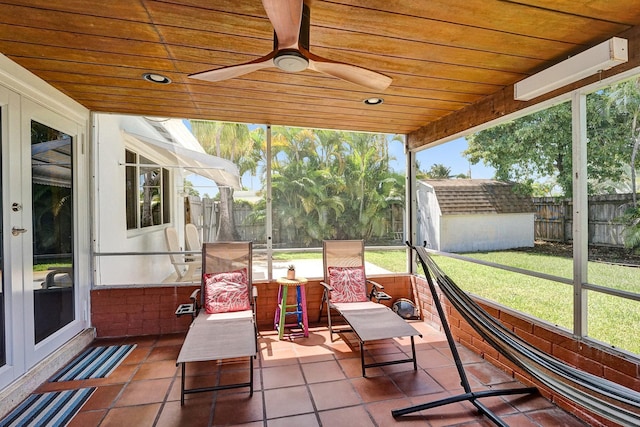 sunroom / solarium with ceiling fan and wooden ceiling