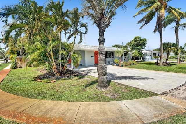 view of front of home with a front lawn and a carport