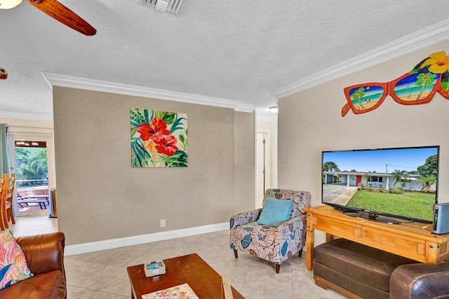 living room featuring ceiling fan, light tile patterned floors, a textured ceiling, and ornamental molding