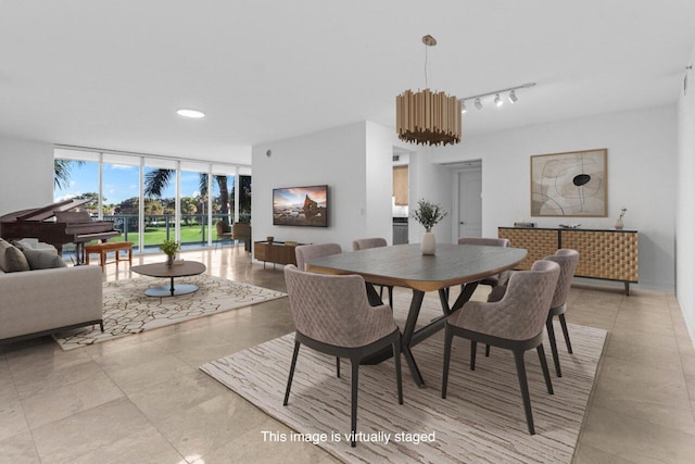 dining room with floor to ceiling windows and track lighting