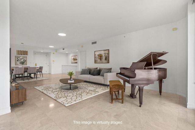 living room featuring baseboards, visible vents, and recessed lighting