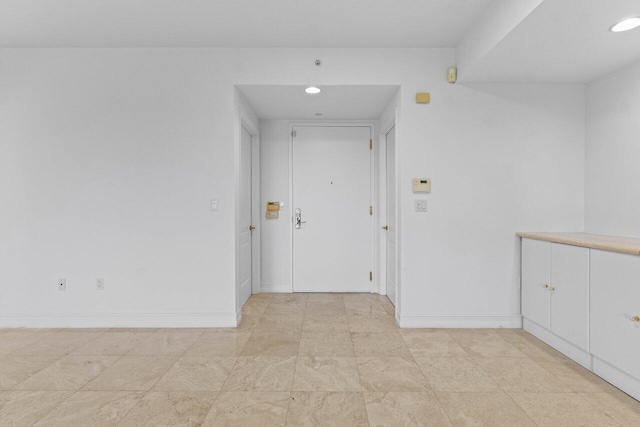 hallway featuring recessed lighting and baseboards