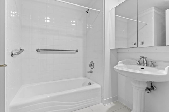 bathroom with tile patterned flooring, baseboards, and shower / tub combination