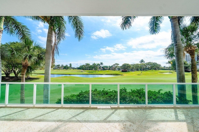 surrounding community with view of golf course, a water view, and a lawn