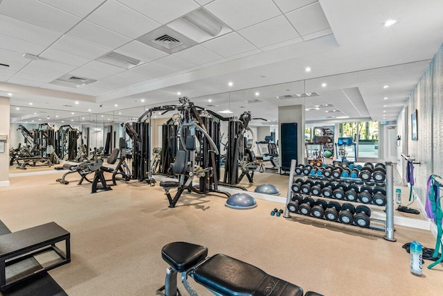 exercise room featuring a paneled ceiling, visible vents, and recessed lighting