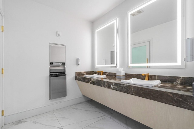 bathroom featuring marble finish floor and vanity