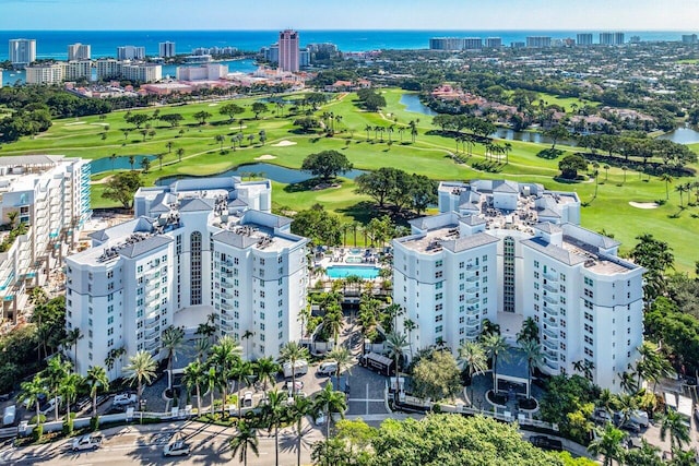 birds eye view of property with a water view, a view of city, and golf course view