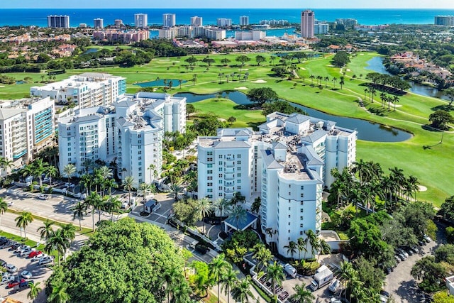 aerial view featuring a view of city, view of golf course, and a water view