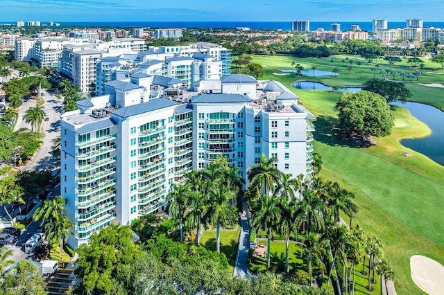 birds eye view of property featuring a view of city, a water view, and golf course view