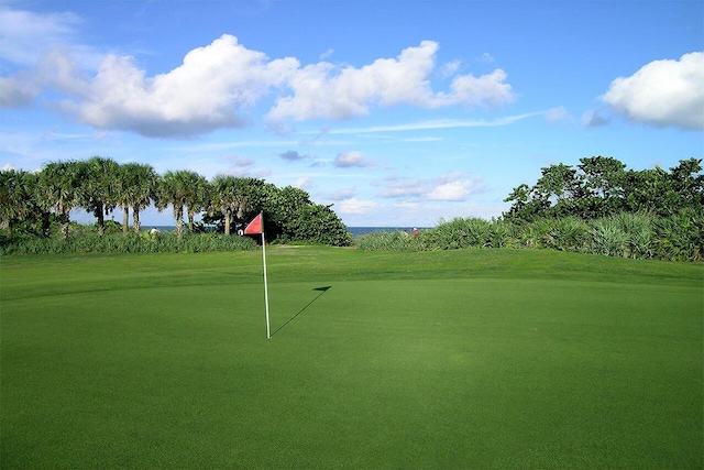 view of community featuring a yard and golf course view