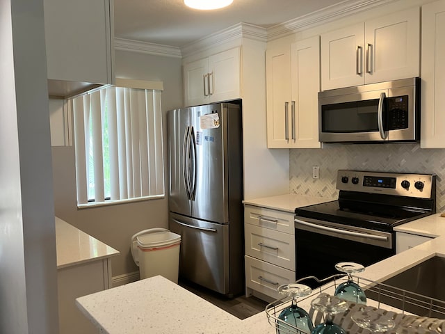 kitchen featuring stainless steel appliances, decorative backsplash, light stone counters, and white cabinetry