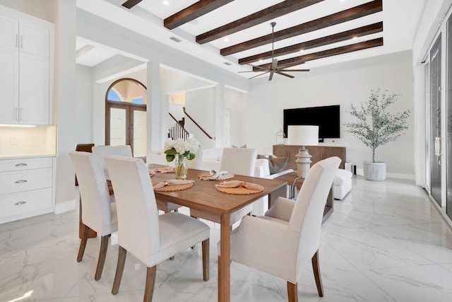 dining area with beamed ceiling, french doors, and a chandelier