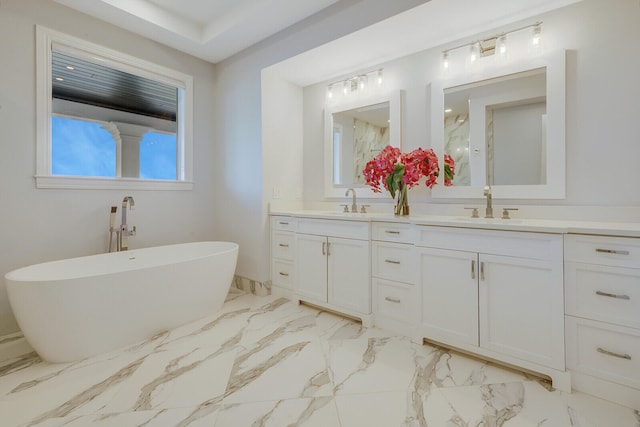 bathroom with vanity and a tub