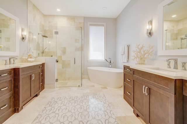 bathroom with vanity and shower with separate bathtub