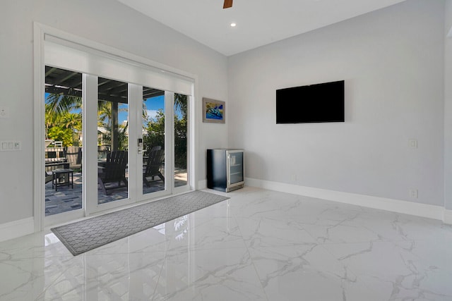 empty room with ceiling fan and french doors