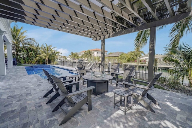 view of patio with a fire pit, a water view, a pergola, and a fenced in pool