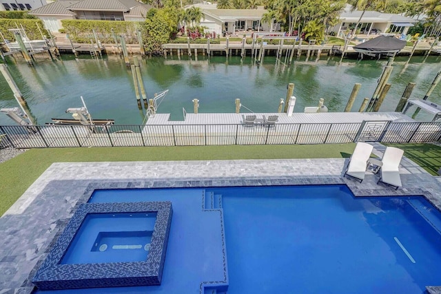 view of pool with an in ground hot tub, a water view, and a boat dock