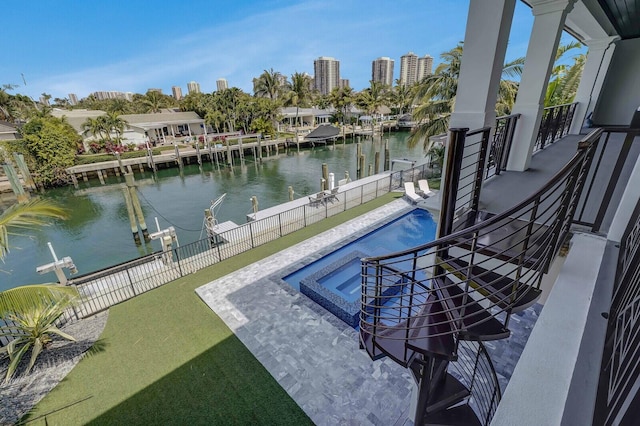 exterior space featuring a boat dock, a water view, and a patio