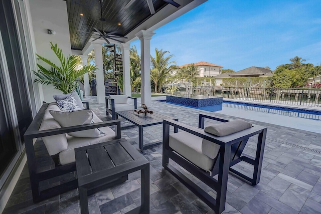 view of patio featuring outdoor lounge area, a fenced in pool, and ceiling fan