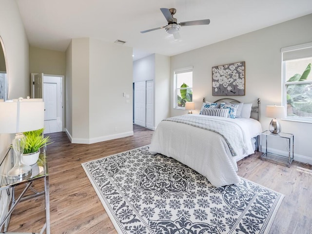 bedroom featuring ceiling fan, wood-type flooring, and a closet