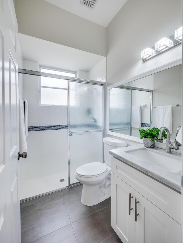 bathroom with vanity, toilet, and an enclosed shower