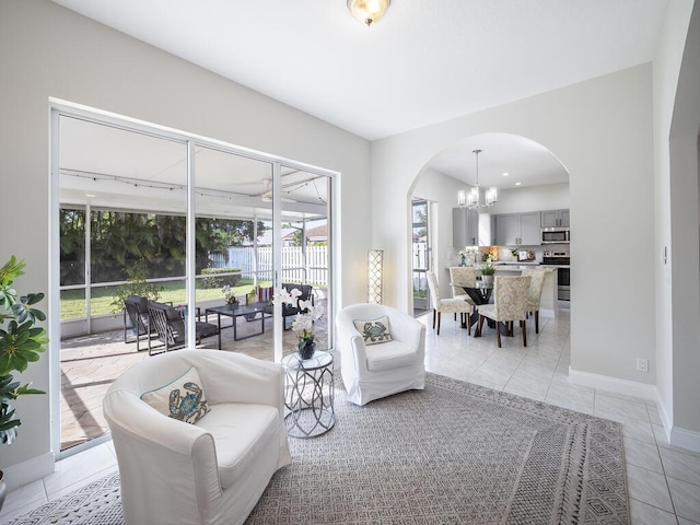 tiled living room with a chandelier