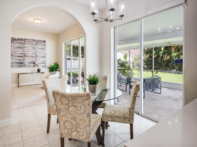 tiled dining space featuring a notable chandelier