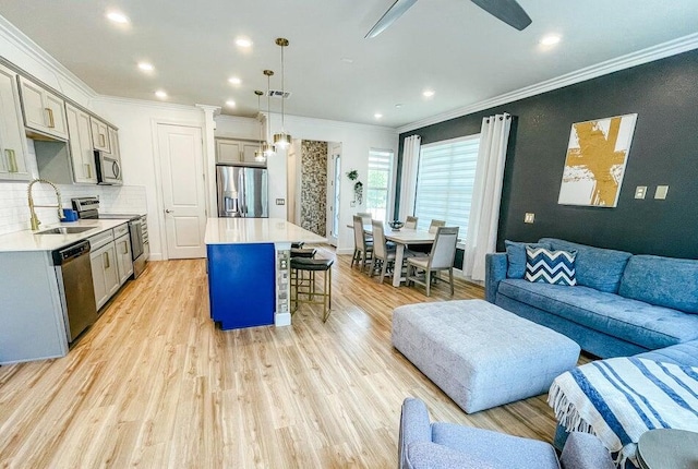 kitchen featuring gray cabinets, a center island, stainless steel appliances, and sink