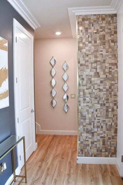 interior space with crown molding and light hardwood / wood-style flooring