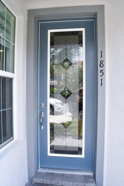 property entrance with stucco siding