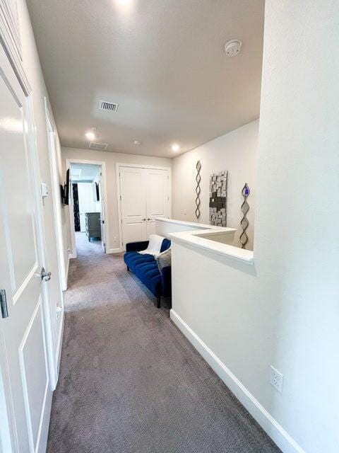 hallway featuring carpet flooring