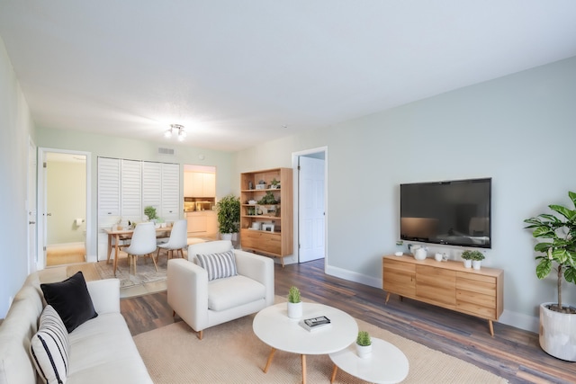 living room with dark hardwood / wood-style flooring