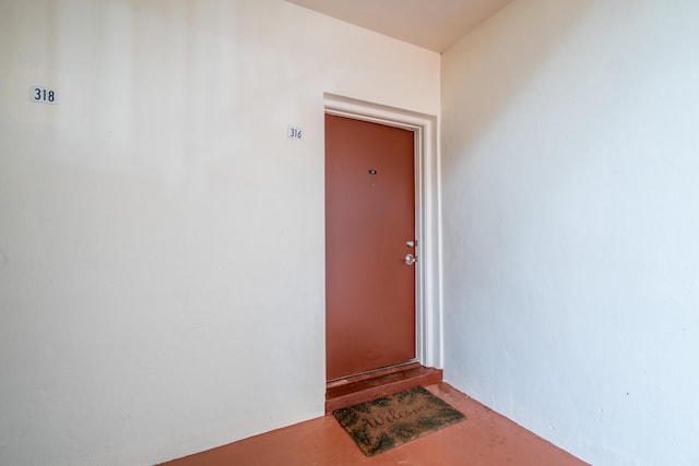 property entrance with stucco siding