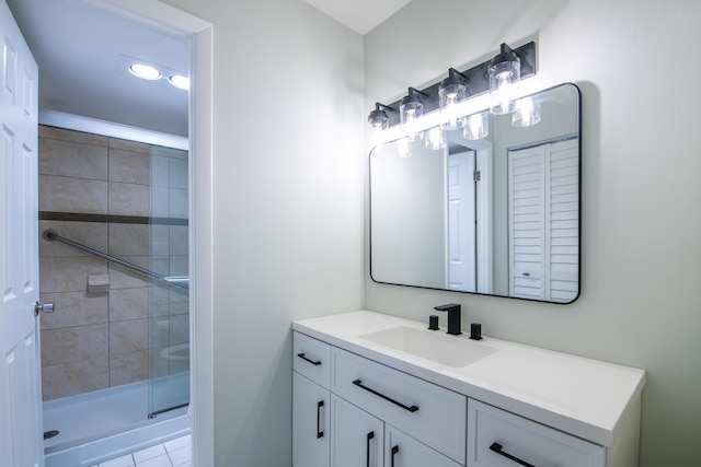 bathroom with vanity, tile patterned flooring, and a shower with door