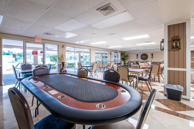 dining space with visible vents, a drop ceiling, and light tile patterned floors