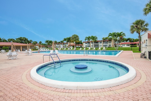 community pool with a patio area