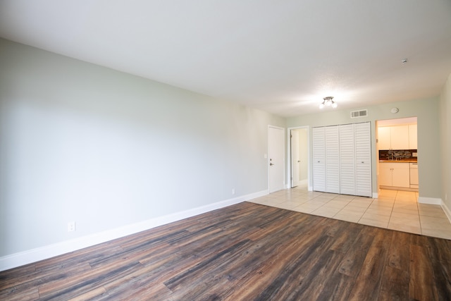 unfurnished bedroom featuring light hardwood / wood-style floors and a closet