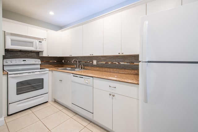 kitchen featuring white cabinetry, backsplash, white appliances, light tile patterned floors, and sink