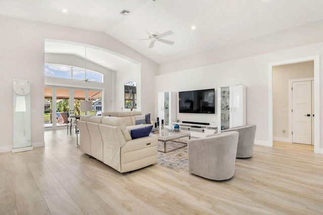 living room featuring light wood-type flooring, ceiling fan, and high vaulted ceiling