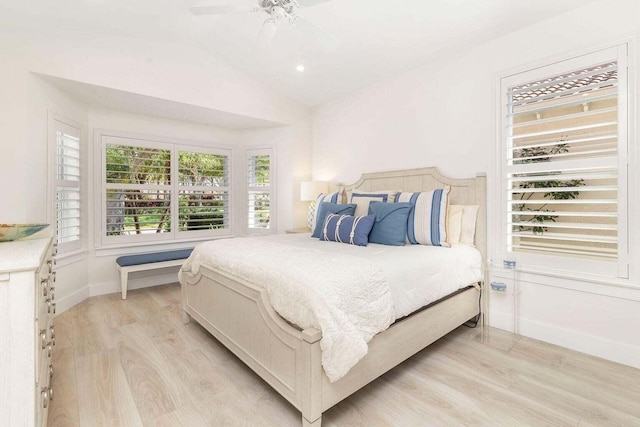 bedroom featuring ceiling fan, vaulted ceiling, and light hardwood / wood-style floors