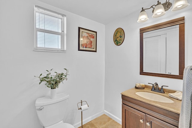 bathroom featuring tile patterned flooring, toilet, and vanity