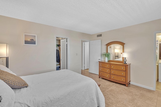 bedroom with a closet and a textured ceiling