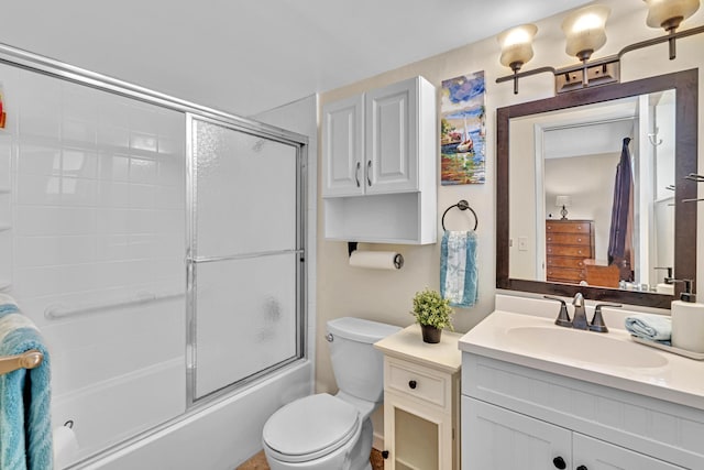 full bathroom with vanity, toilet, and combined bath / shower with glass door