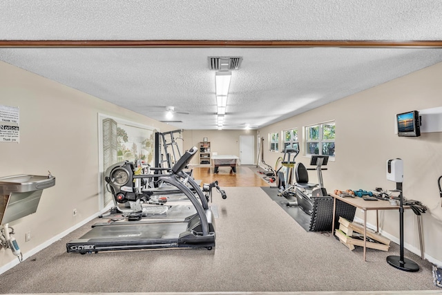 exercise room featuring a textured ceiling