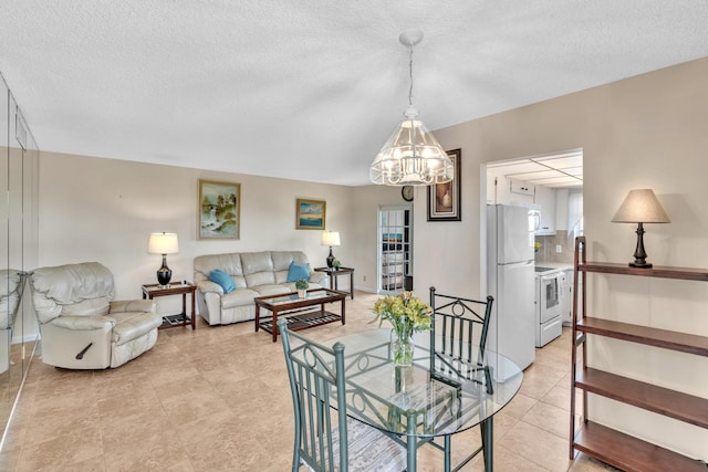 living room featuring a textured ceiling, a chandelier, and light tile patterned flooring