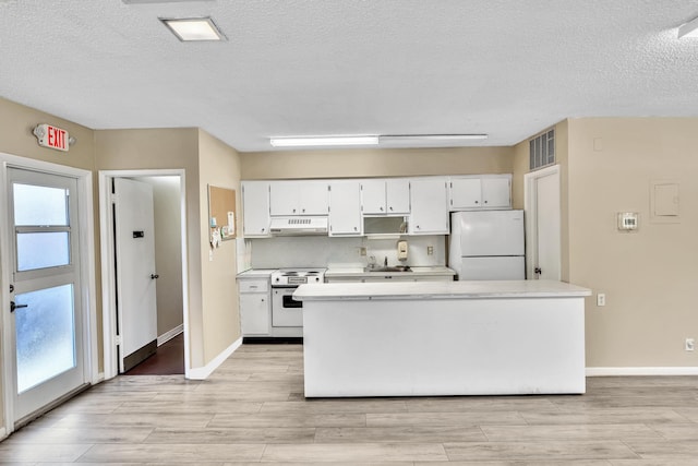 kitchen with white cabinets, light hardwood / wood-style flooring, white appliances, sink, and a textured ceiling