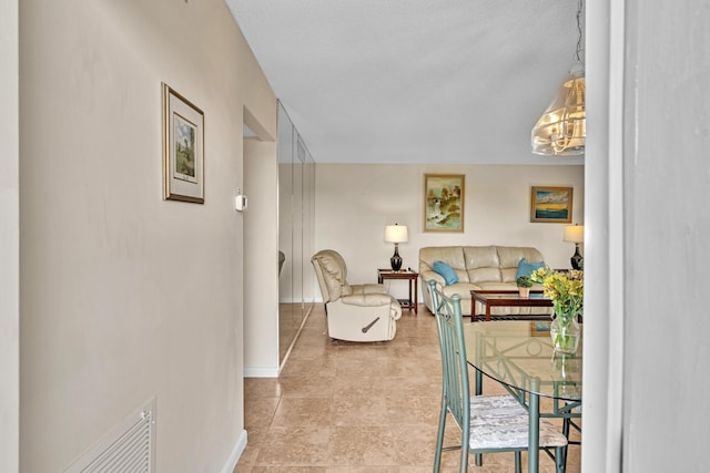 interior space with a notable chandelier and a textured ceiling