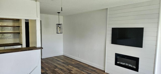 unfurnished living room featuring dark wood-type flooring